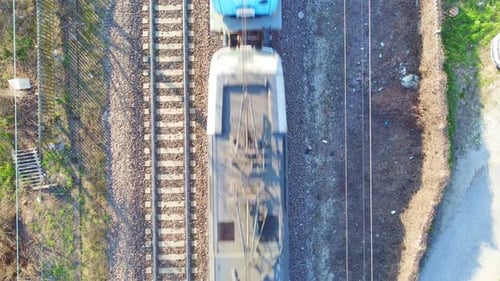 Birds Eye View of a Train Traveling Along Railway Tracks