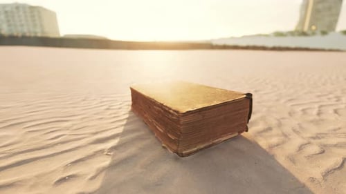 Old Book on the Sand Beach