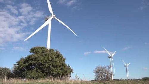 Wind turbines turning in strong winds.