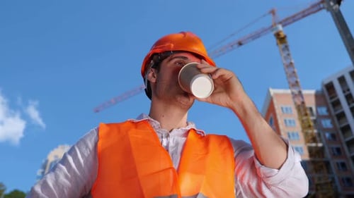 Builder in Working Uniform Drinking Coffee While Standing Construction Site Business Building