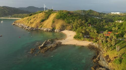Yanui beach aerial with palm trees and wind turbine, Phuket, Thailand