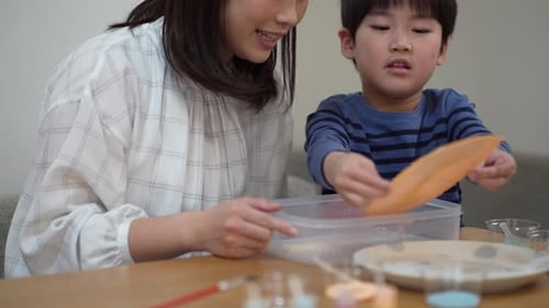 Woman and Boy Doing Art Project Together at Table