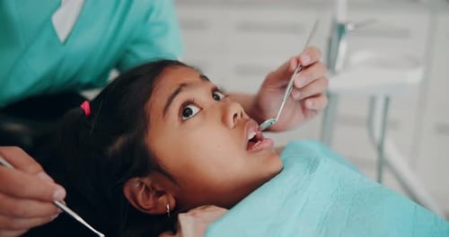 Child Dental Exam with Dentist Using Mirror