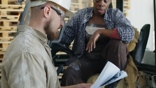 Storehouse Workers Discussing Goods Transportation