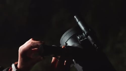 Adjusting Telescope for Stargazing at Night in Nature