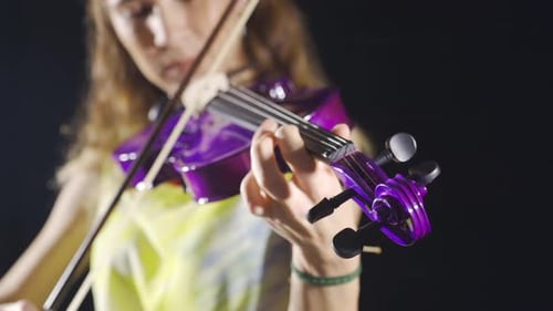 Close-up musician woman playing the violin.