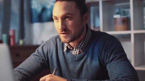 A Focused and Dedicated Professional Working on Their Laptop in a Home Office Environment