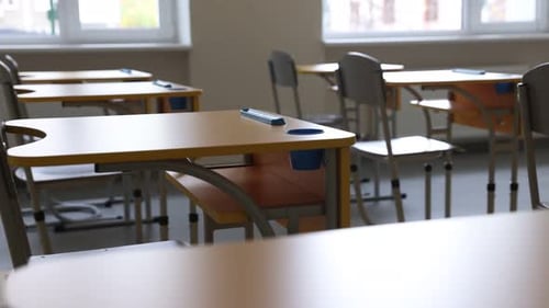 Stylish classroom with desks and chairs at school, closeup