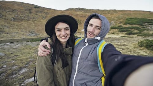 Happy Couple Taking Selfie in Mountain Landscape
