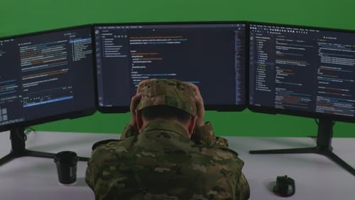 Asian Man Soldier Having Headache While Write Code With Multiple Computer Screens In Green Screen