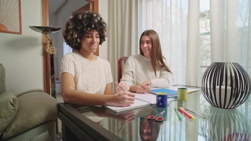 Two Young Women Studying Together at Home