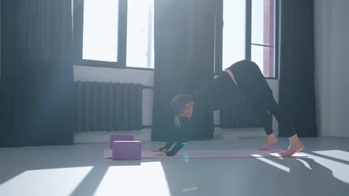 Woman Doing Yoga, Plank to Downward Dog