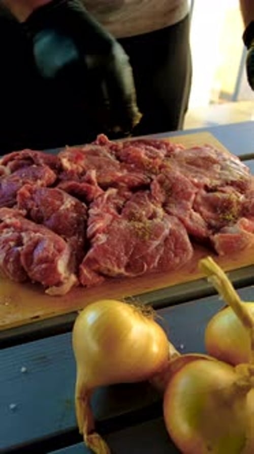 Seasoning Fresh Meat on a Cutting Board