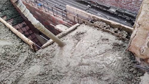 12-01-24; A worker is settling cement through concrete vibrator pipe on the roof