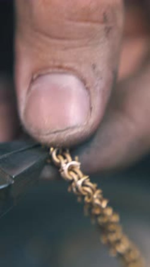 Goldsmith Cuts Leftovers From Chain with Pliers Close View