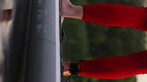 Person on Paddle Board Wearing Red Wetsuit