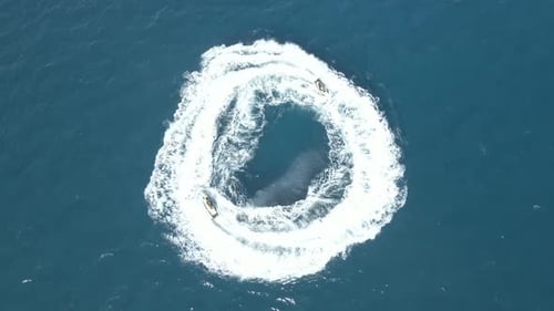 Two Jet Skis Draw Circles on the Ocean
