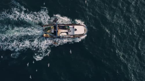 Fishing Vessel Boat Floating in the Blue Sea Aerial View From Drone