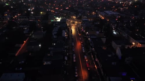 Aerial top down of parking cars along street in quiet small town of USA at night. Lighting lantern i