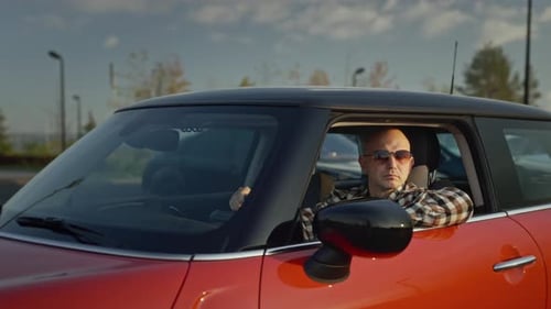 Man with Sunglasses Sitting in Red Car