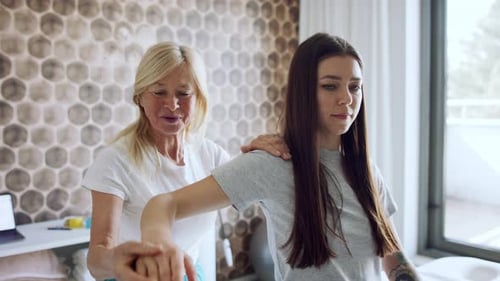 Woman Receives Upper Body Massage from Therapist