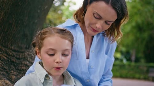 Little Kid Reading Novel Spending Time with Mom Together Green Garden Portrait