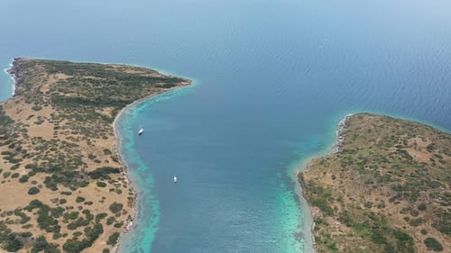 Sailboat Gliding Toward a Picturesque Island Coastline