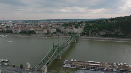 Aerial View of Steel Road Bridge Over Wide River in City Vehicles Driving on Bridge and Along Water