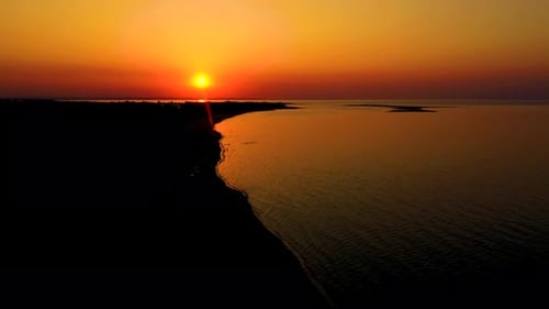 4K UHD Aerial drone view Beautiful sunset over tropical beach with clouds In the middle of the sea