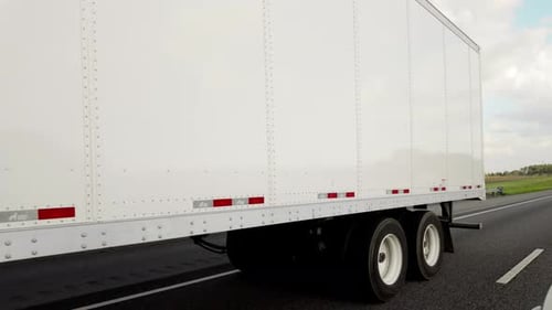 View of Semi Truck Driving on American Interstate Freeway Delivering Cargo Concept