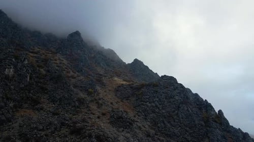 Aerial view a mountain with a foggy mist on it