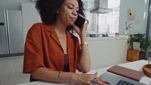Woman Working from Home on Laptop and Phone