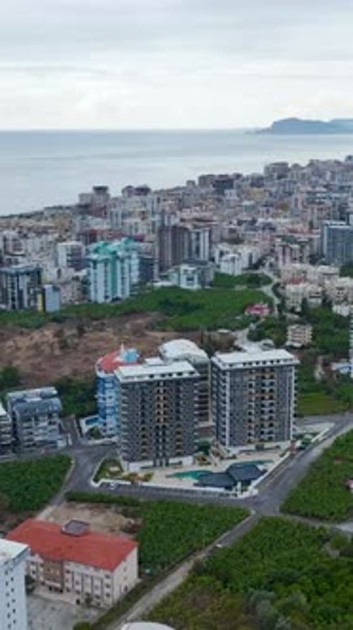 Vertical Video Modern Residential Complexes with Sparkling Pools Vibrant Green Areas and Elegant