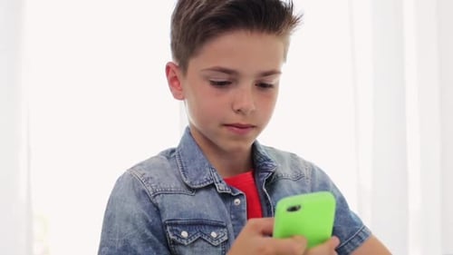 Boy Using Mobile Phone with Green Protective Case