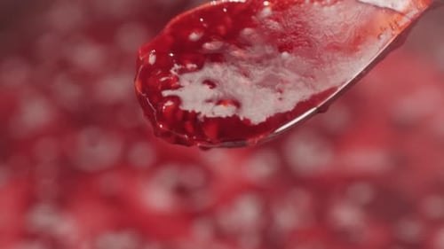 Close Up Spoon of Thick Raspberry Jam