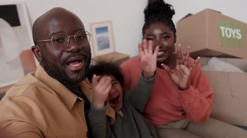 Joyful Family Waving in Their New Home
