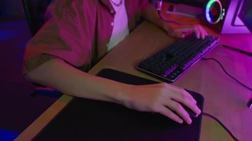 Young Adult Plays Computer Game At Home At Night