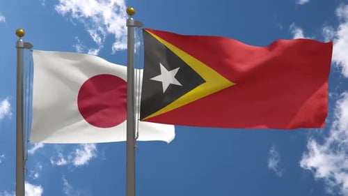 Flagge Japans gegen Flagge Osttimors am Fahnenmast