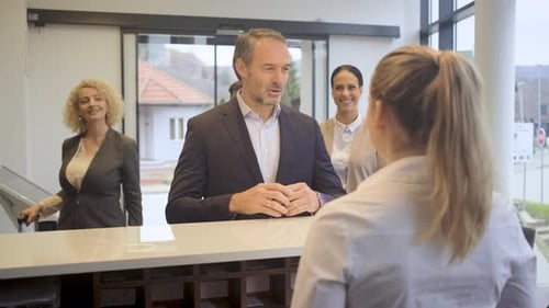 Group of business people arriving in a hotel for a business conference.