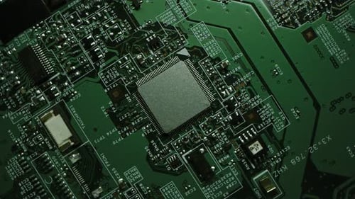 Focus on a Microchip, CPU Processor. Green Printed Circuit Board, Computer Motherboard with Compone