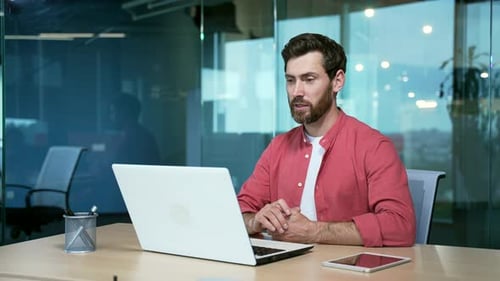 mature bearded businessman entrepreneur talking online on video call sitting in office at workplace