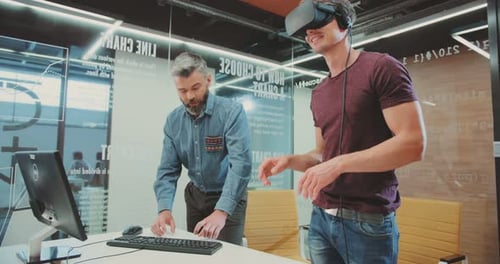 NEW YORK April 5 2017Attractive Guy in Virtual Reality Glasses Two Smart Men Using Illusion