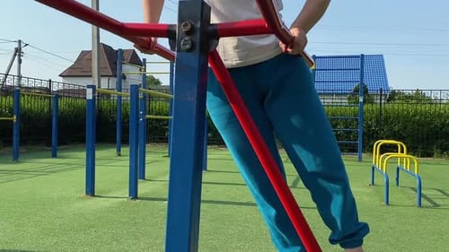 Young woman works out at the sport area outdoors