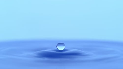 Water drop ripples on liquid surface in slow motion