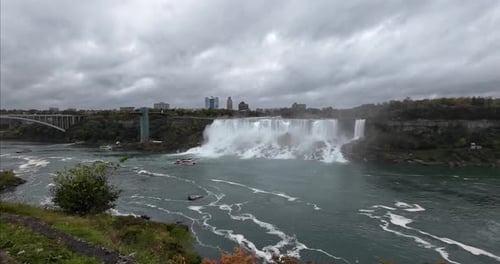 Niagara Falls from the Canadian side overlooking the waterfalls on the American side on a cloudy day
