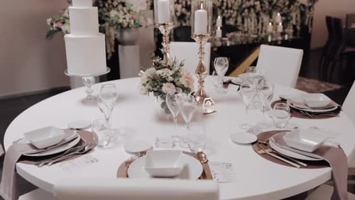 Elegant Wedding Table Setting With Cake and Flowers