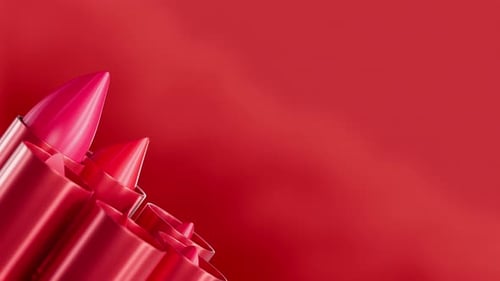 Set mit rotem Lippenstift, herausziehbar und drehbar vor rotem Hintergrund, Nahaufnahme von Glamour-Kosmetik