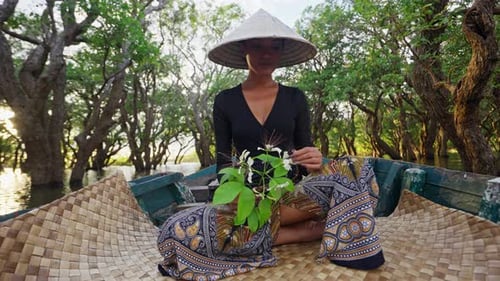 Woman with Hat in a Boat on Tropical River