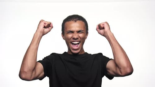Man Cheering With Arms Raised in Excitement