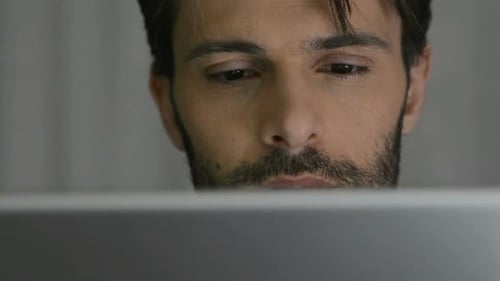 Concentrated Man Using Tablet at Night